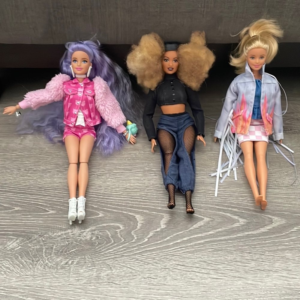 Three Barbie dolls with clothes